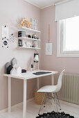 Shell chair at desk in child's bedroom in pink and white
