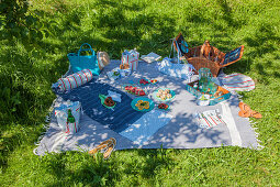 Handmade fabric accessories and snacks on picnic blanket