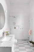 White bathroom with checkerboard floor and walk-in shower