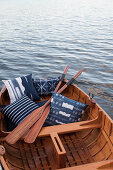 Blue patterned pillows in a rowboat on the lake