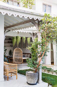 Covered terrace at the exotic house with a summer garden