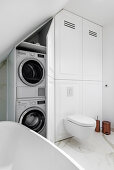 Elegantes Badezimmer, Waschmaschine und Trockner im Einbauschrank