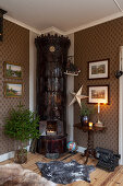 Dark tiled stove in corner of festively decorated living room