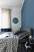 Blue wall in Japandi-style bedroom