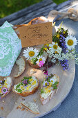 White bread and floral butter decorated with wild summer flowers