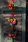 Kleine Kränze aus Weidengeflecht dekoriert mit bunten Filzblumen und Filzherzen