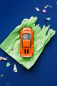 Toy car on green wrapping paper