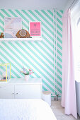Bedroom wall with diagonal white and turquoise stripes