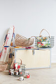 Wooden trunk, wire baskets and raffia baskets for storing toys