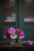 Pink and white roses in metal vase