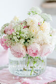 Bouquet of roses and ground elder flowers in pastel shades
