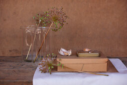 Dried garlic flowers in glass jars, cardboard box, tin and garlic cloves
