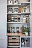 Open storage cupboard in a country house kitchen