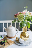 Flower in golden vase on set table