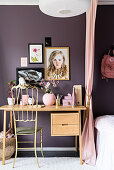 Golden chair at desk against purple wall in child's bedroom