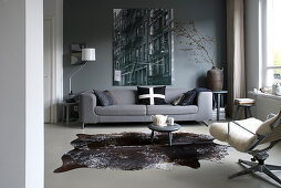 Wintry living room in shades of grey with cowhide rug