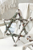DIY star made of twigs wrapped with lichen