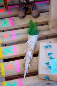 pine branches wrapped in paper with a pennant chain made of washi tape