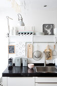 Kitchen utensils on and above black worksurface