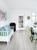 Extendable Swedish bench in the dining room with colorful chairs