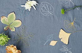 An embroidered cloth with autumnal leaves