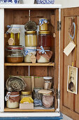 Old wooden cupboard with honey, honeycombs, and nostalgic decoration