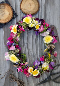 Wreath of sweet peas, everlasting flowers, chrysanthemums, sedum, and goldenrod