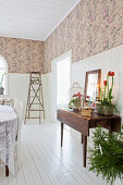 Living room with wallpaper and white wood paneling in a restored mission style house