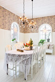 Dining table with lace tablecloth in a restored mission style house