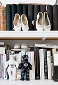 Ballet shoes and voodoo dolls on a bookshelf