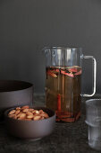 Glass carafe of mulled wine with apples and cinnamon