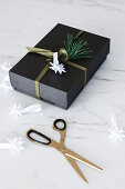 Wrapped Christmas present with handmade origami Christmas star