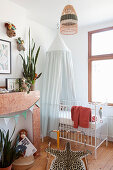 Cot with canopy in vintage-style child's bedroom