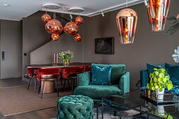Turquoise velvet furniture in seating area with designer lamps