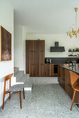 Elegant, custom kitchen and island counter with wooden fronts in split-level house
