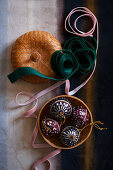 Four Christmas baubles in jewellery box and ribbons