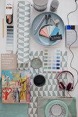 Renovation utensils: paint sample cards, can of paint, book and headphones