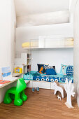 Bunk beds in alcove and shelves used as steps in children's bedroom