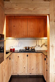 U-shaped fitted kitchen with wooden cupboards