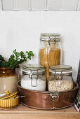 Pasta and oatmeal in storage jars in cake tin
