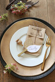 Place setting decorated with handmade name card and gift bag