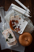 Handmade scented wax tablets with flowers and leaves lying on tissue paper