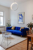 Royal-blue sofa, retro chair and coffee table in living room