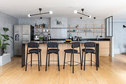 Open-plan kitchen with counter and barstools