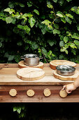Child's hands turning wooden oven control of outdoor play kitchen