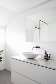 Washstand and mirror in white bathroom