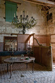 Chandelier and candelabras on table in old stable