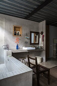 Concrete wall and metal ceiling in ensuite bathroom