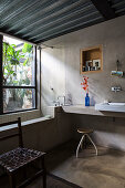 Ensuite bathroom with concrete wall and metal ceiling