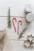 Sprigs of rosemary, candy canes, pillar candles and pastry cutters